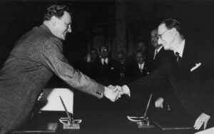 La firme dal Pat: De Gasperi (diestre) e Gruber (çampe) 5 di Setembar 1946 – 5 di Setembar 2026